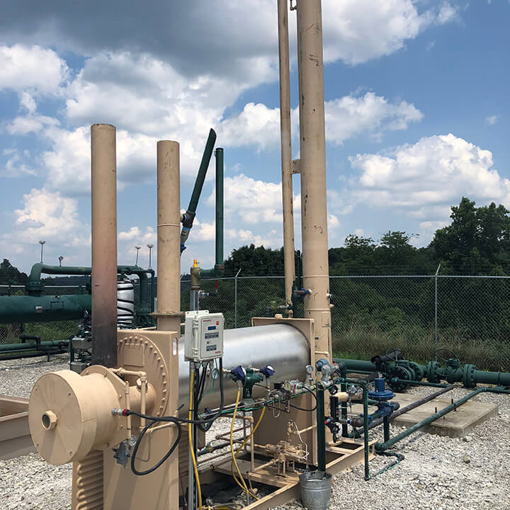 Industrial equipment with pipes and blue sky background.